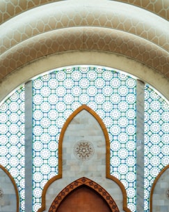A large wooden door in front of a stained glass window