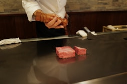A man in a chef's uniform preparing food on a counter
