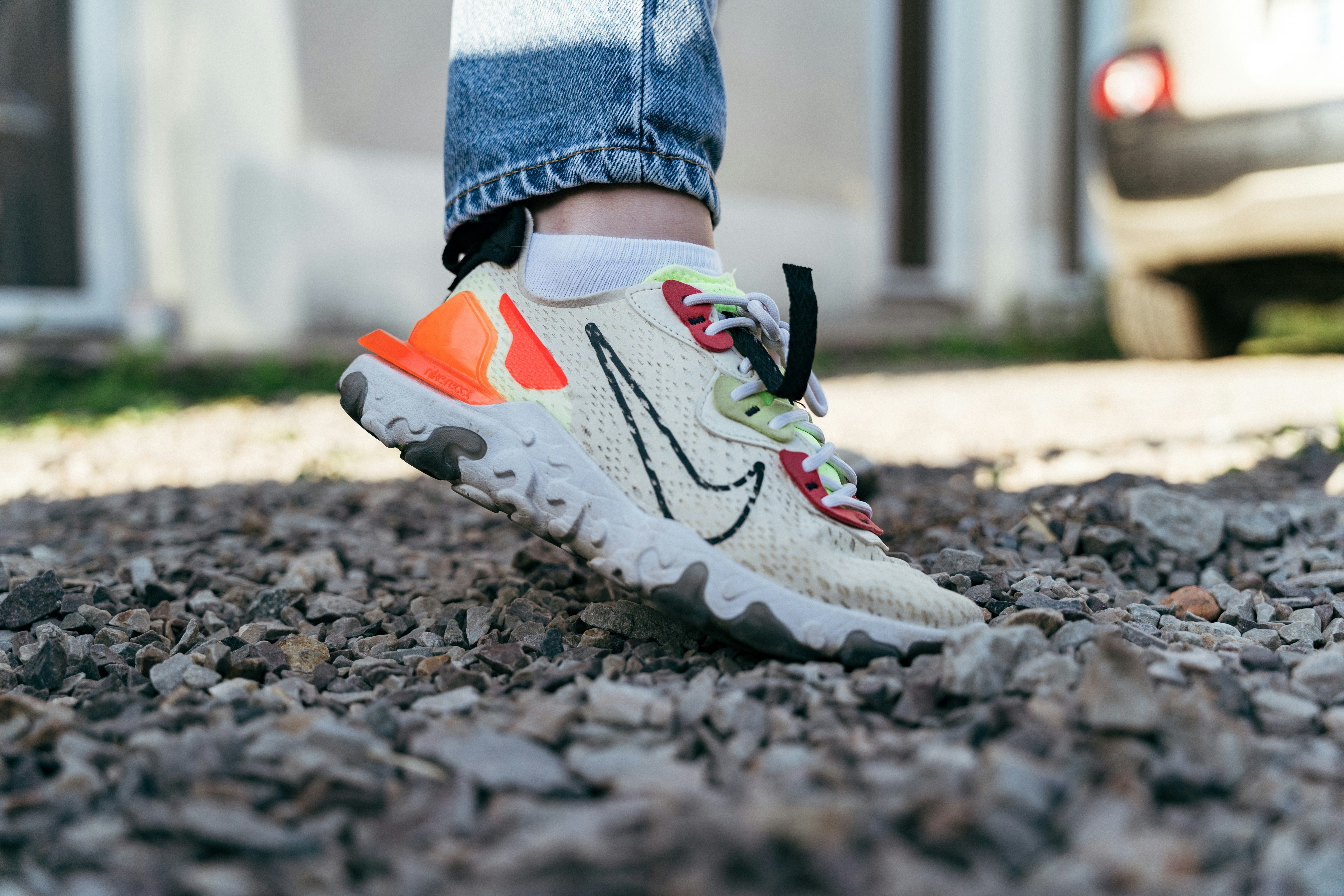 A person's feet in a pair of sneakers