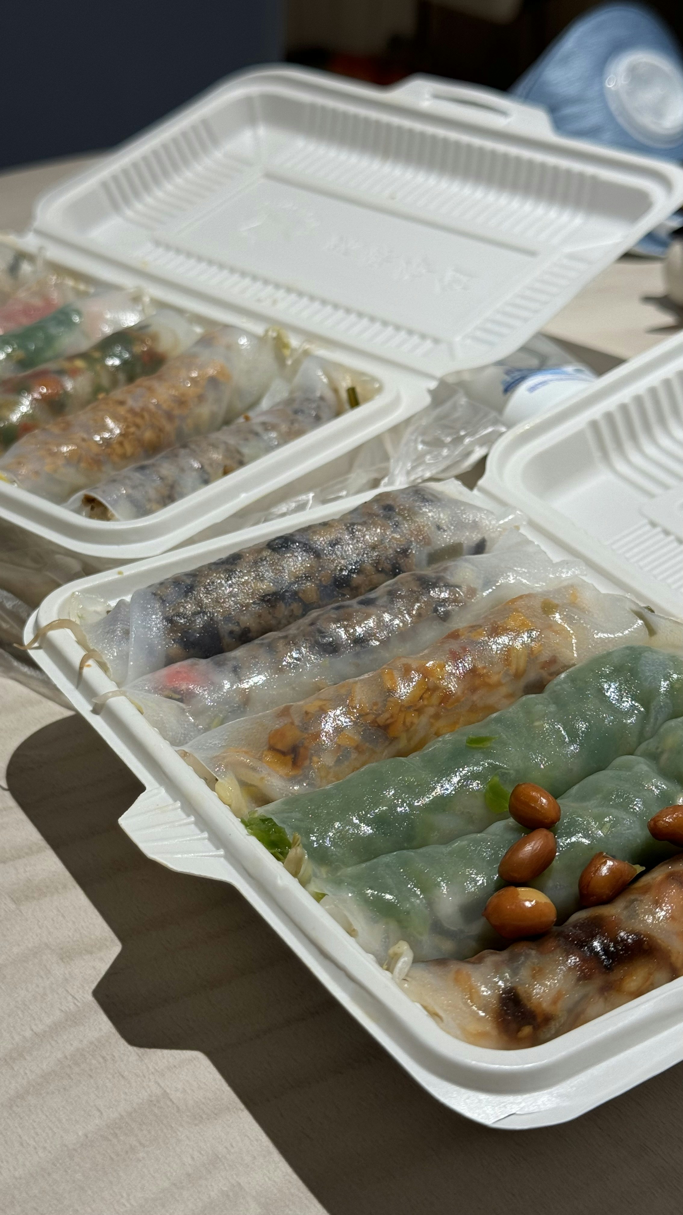 A table topped with plastic containers filled with food