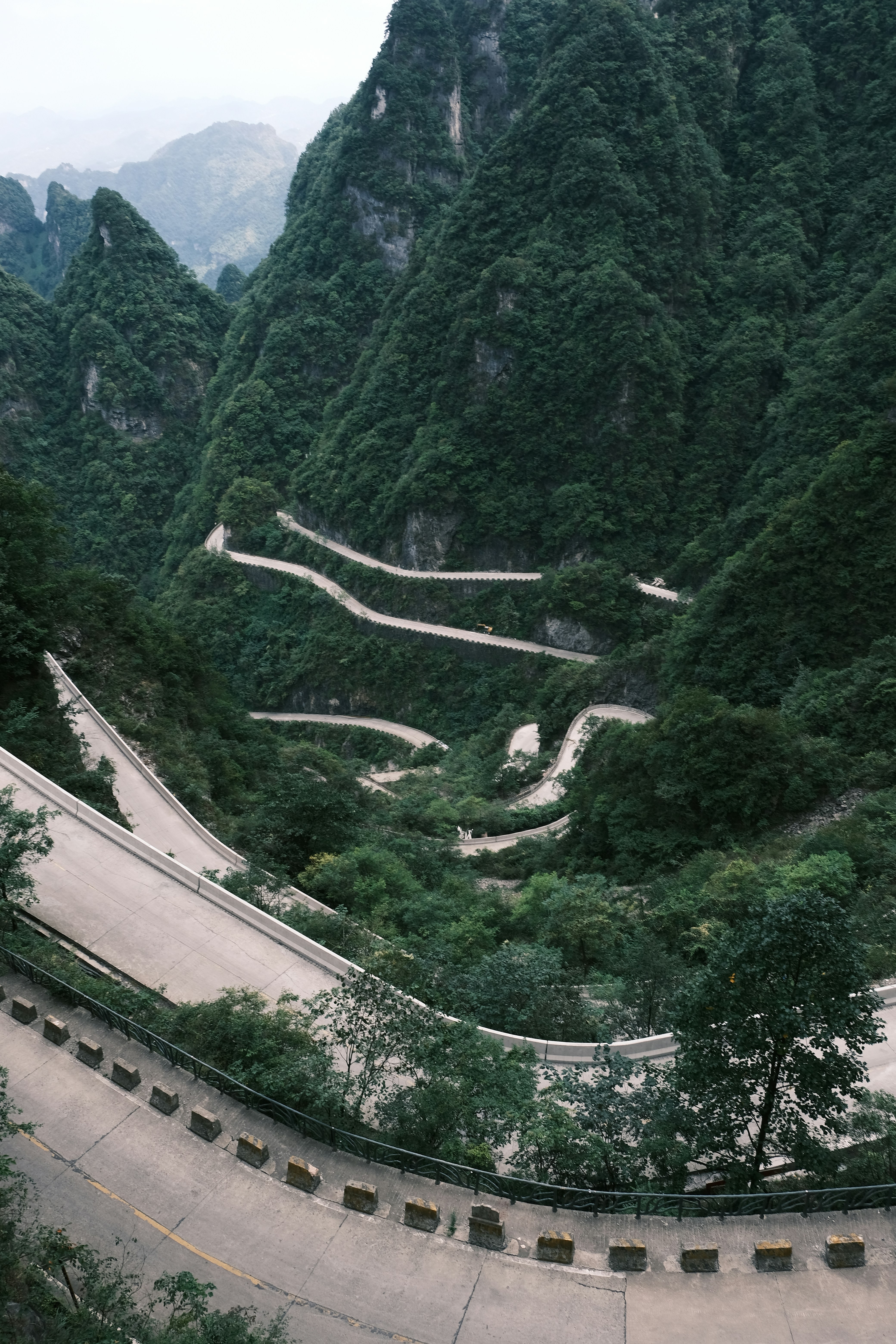 A winding mountain road surrounded by green mountains photo – Free ...