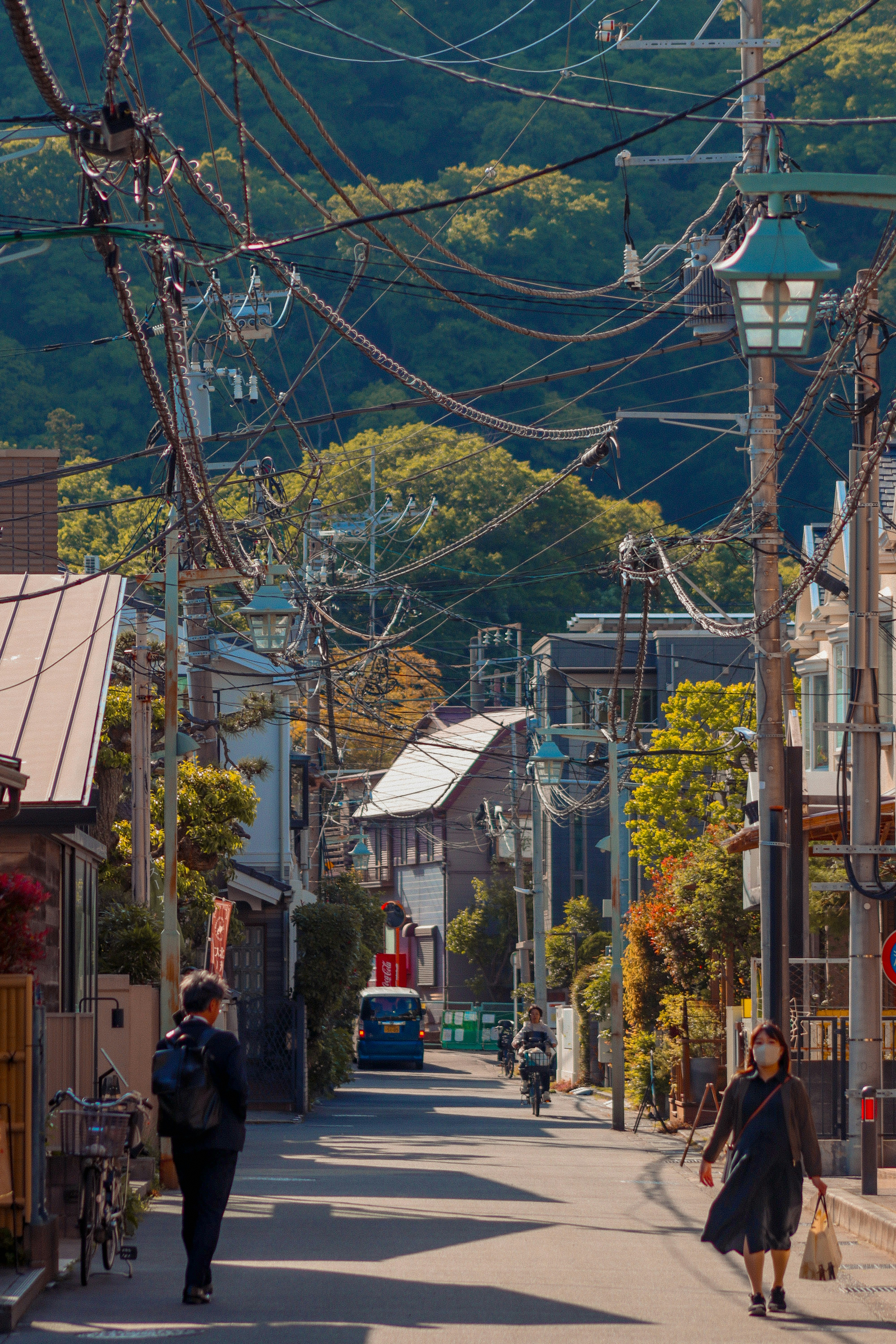 A couple of people walking down a street