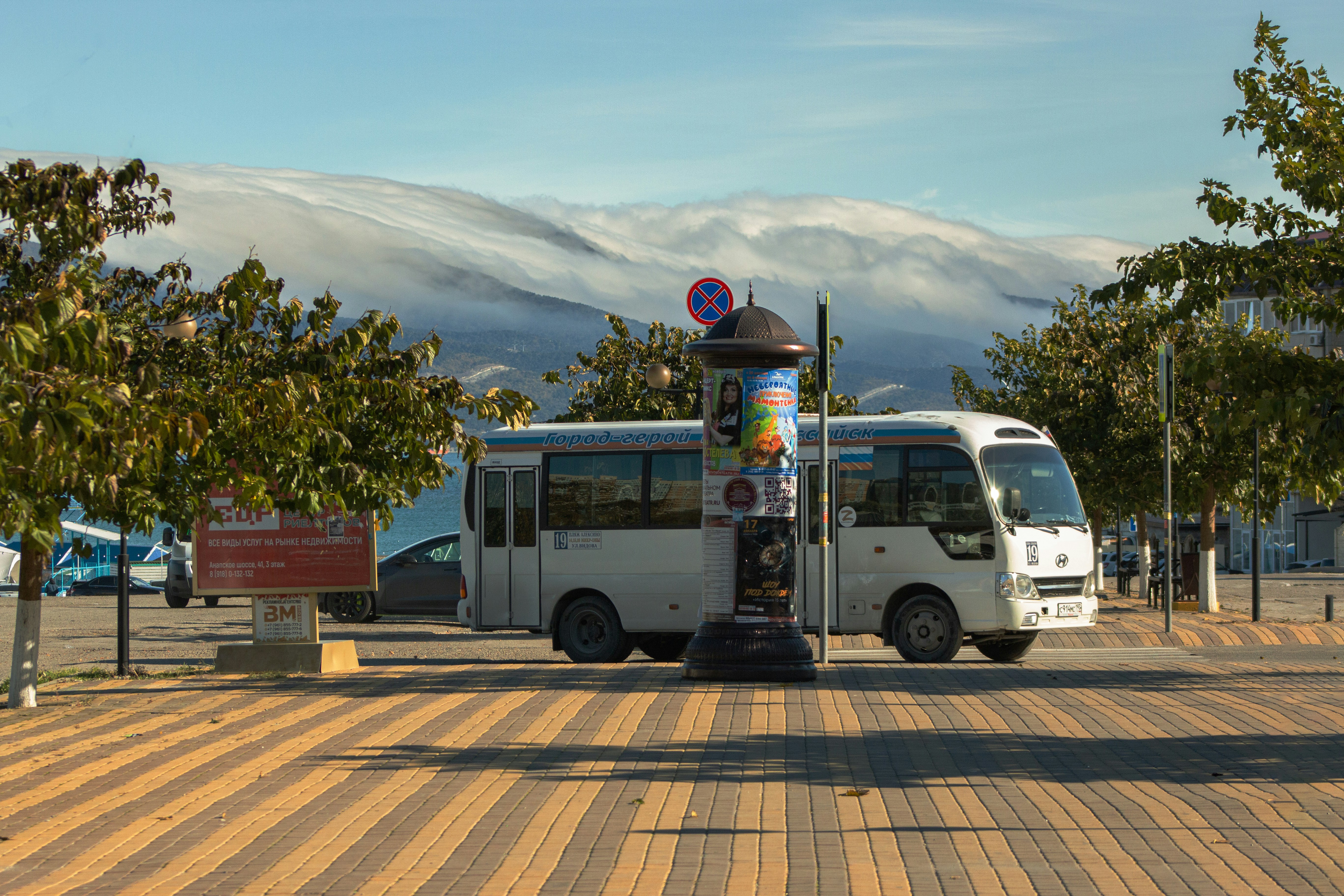 A white bus parked on the side of a road