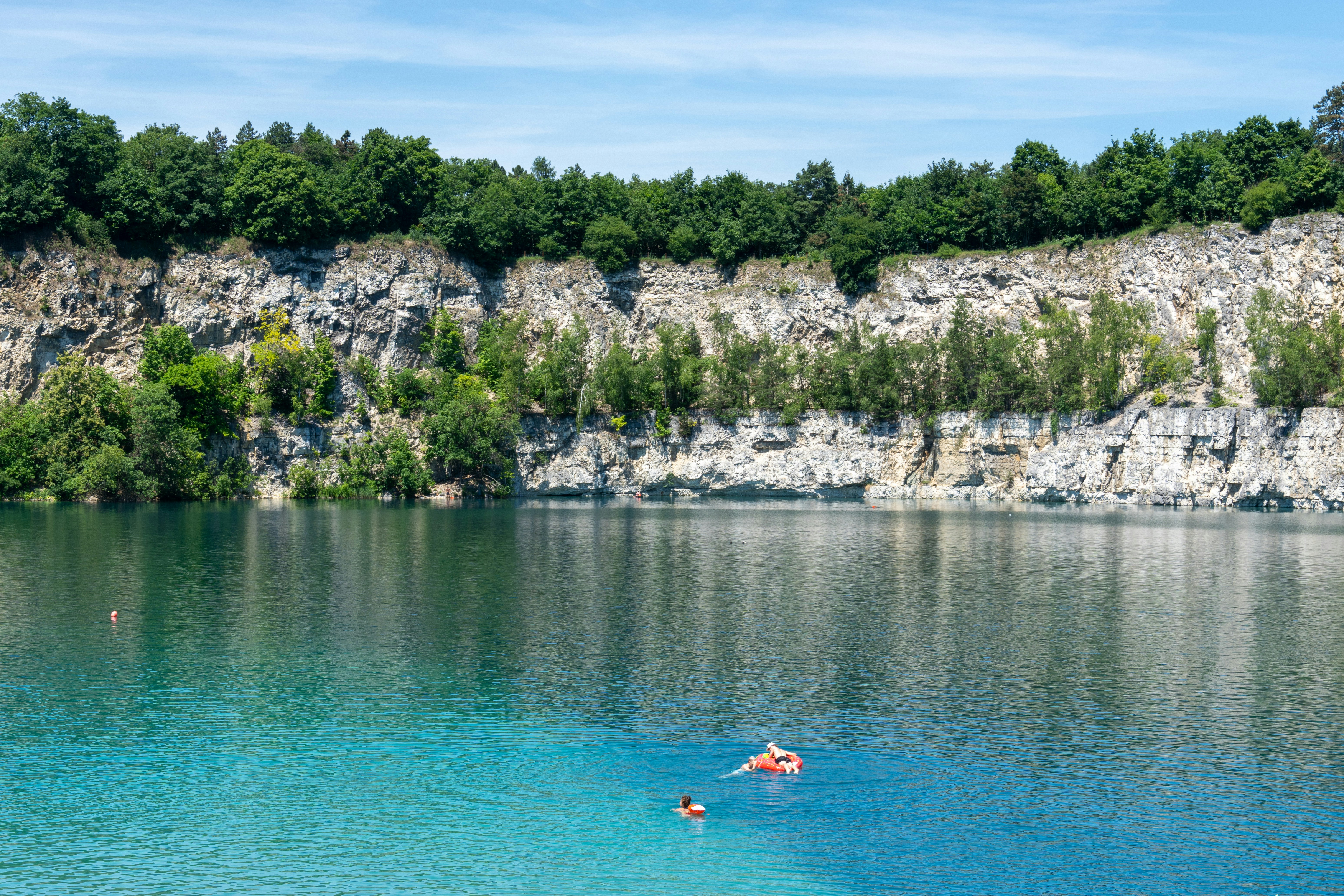 People swimming in the waters of Zakrzowek Park illustrating summer activities in Krakow