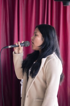 A woman standing in front of a microphone