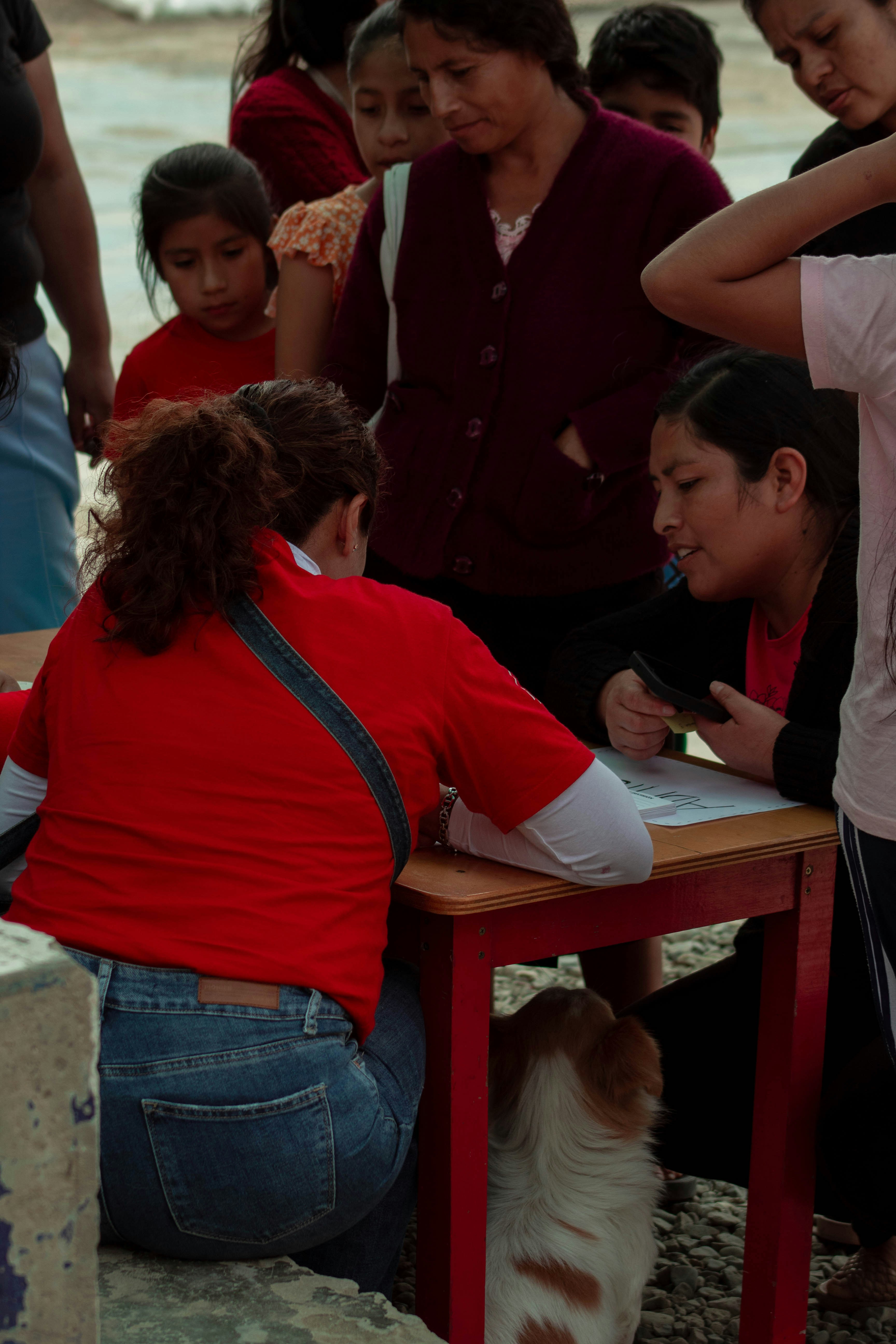 A group of people standing around a table photo – Free Woman Image on ...