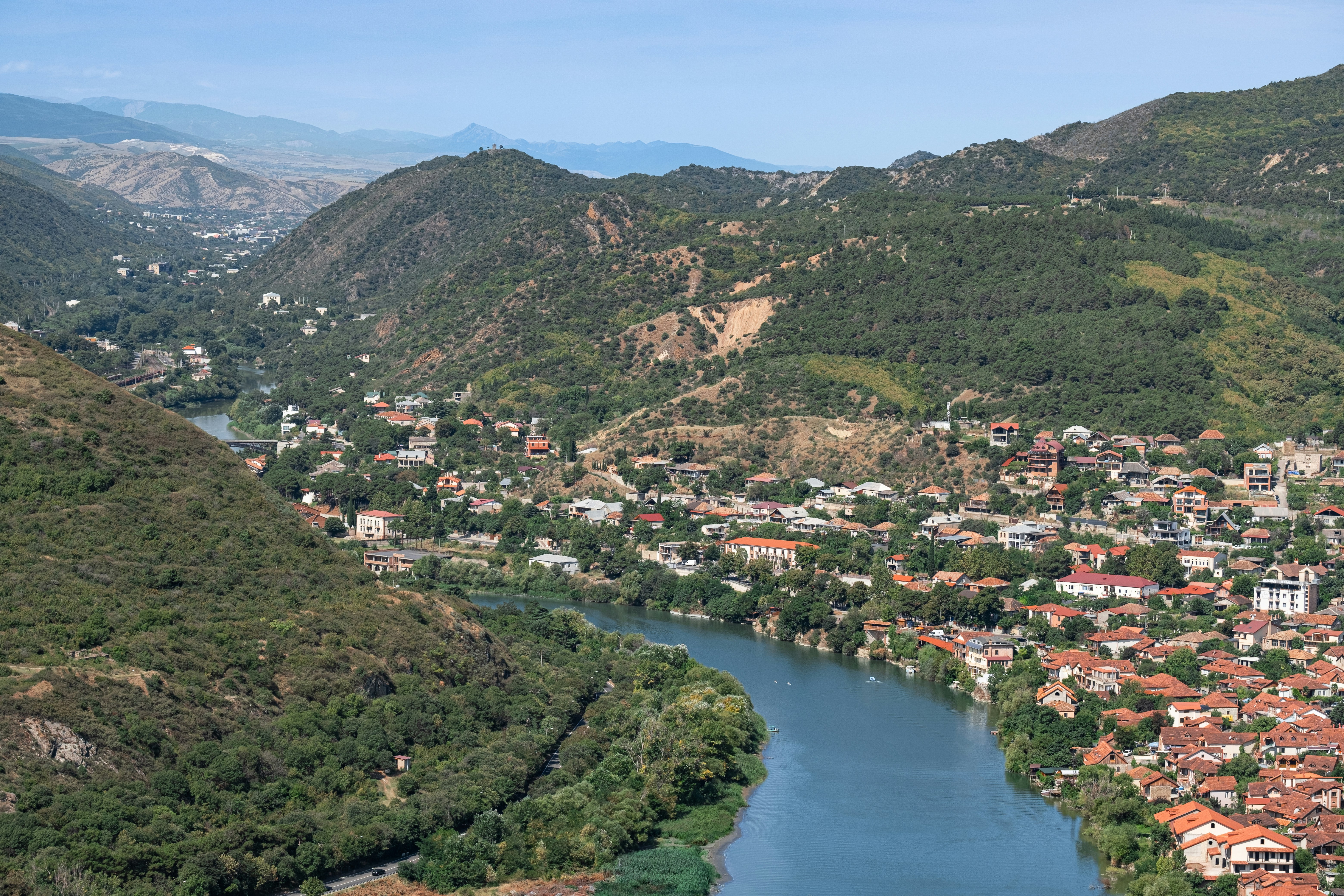 A river running through a lush green hillside