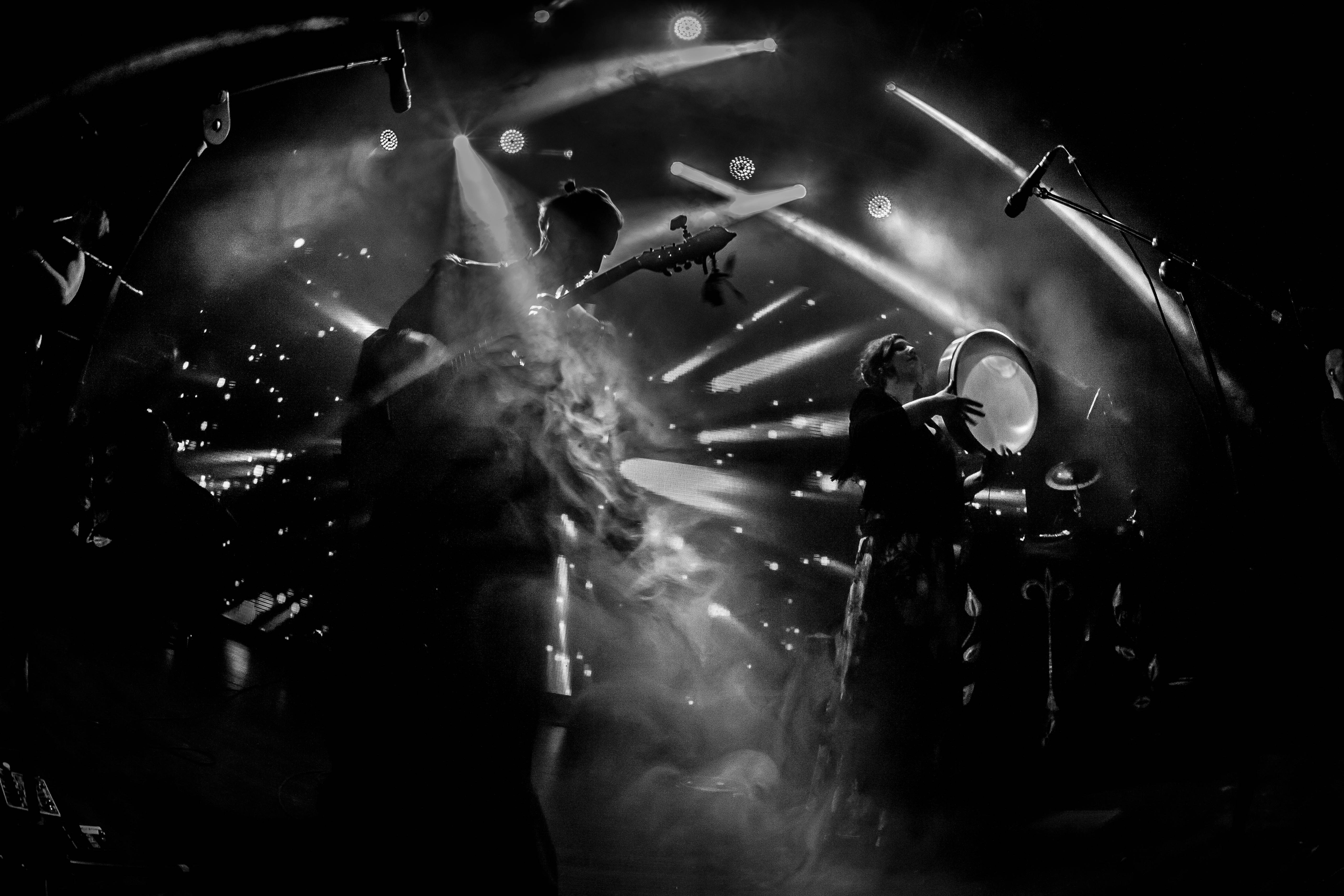 A black and white photo of a band on stage
