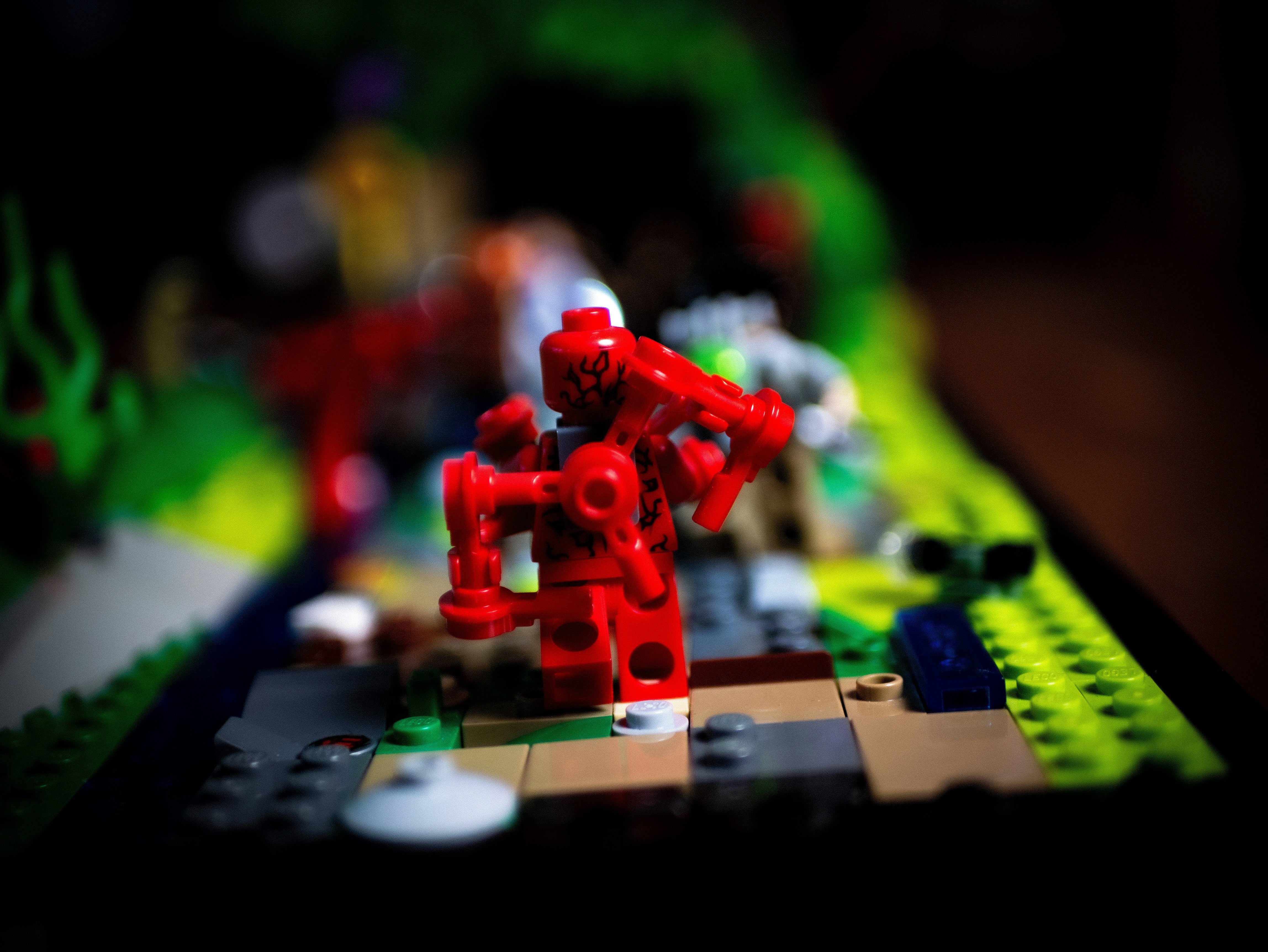 A close up of a lego model of a red robot