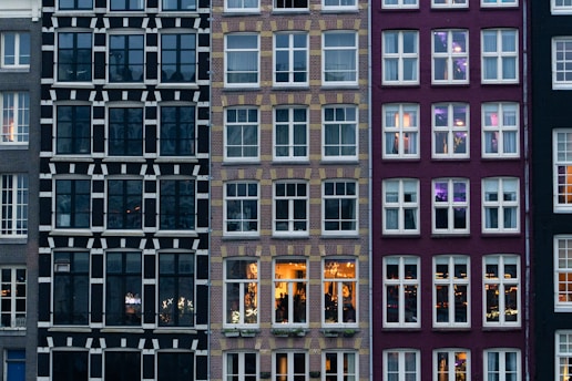 A row of tall buildings with lots of windows