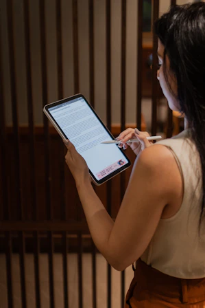 A woman holding a tablet in her hands