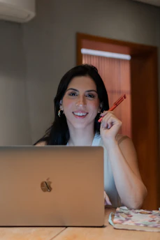 A woman sitting in front of a laptop computer