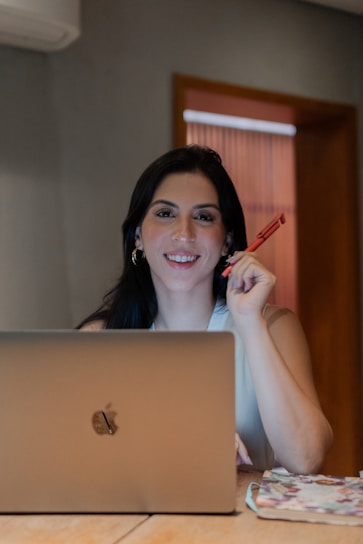 A woman sitting in front of a laptop computer