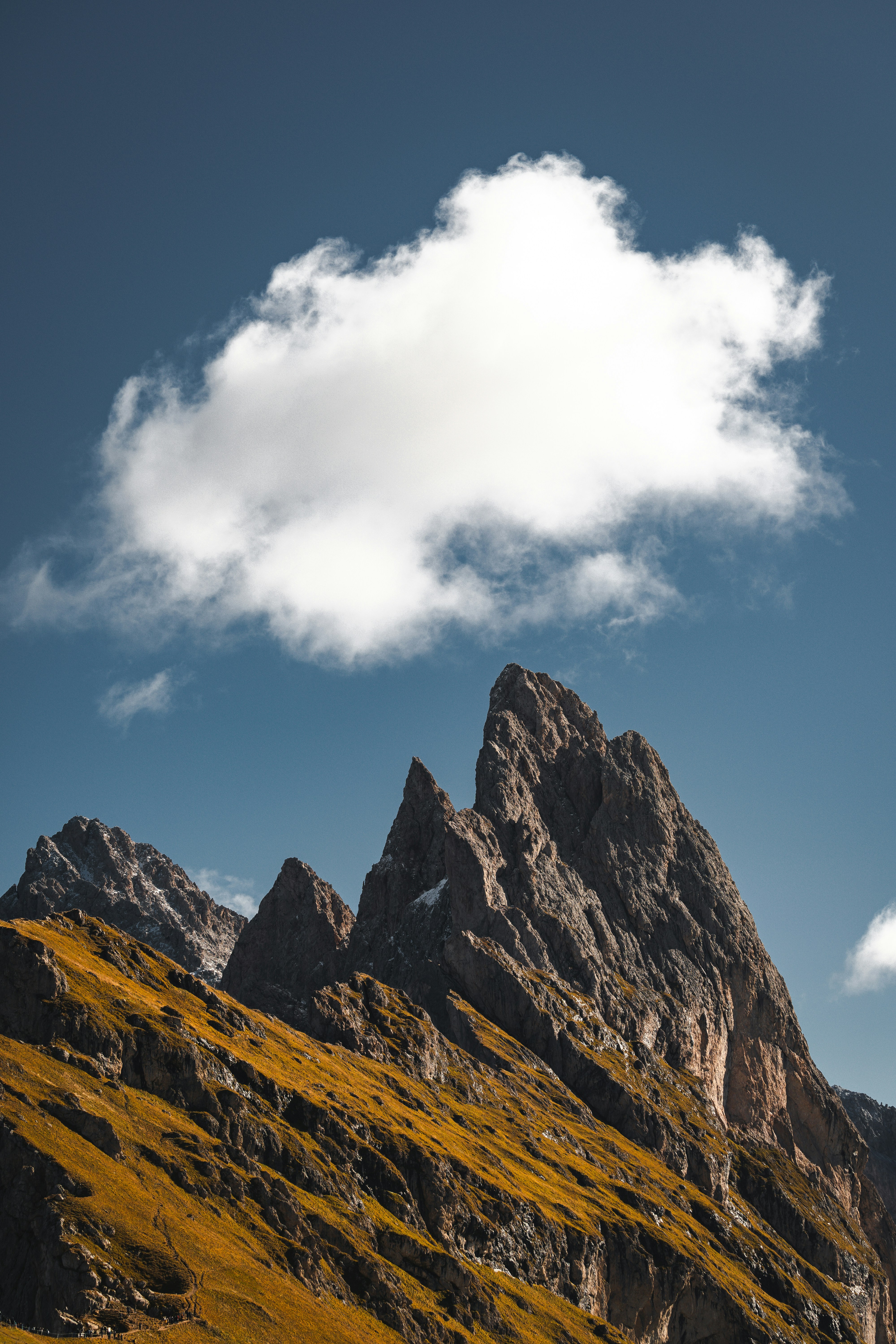 A mountain with a cloud in the sky