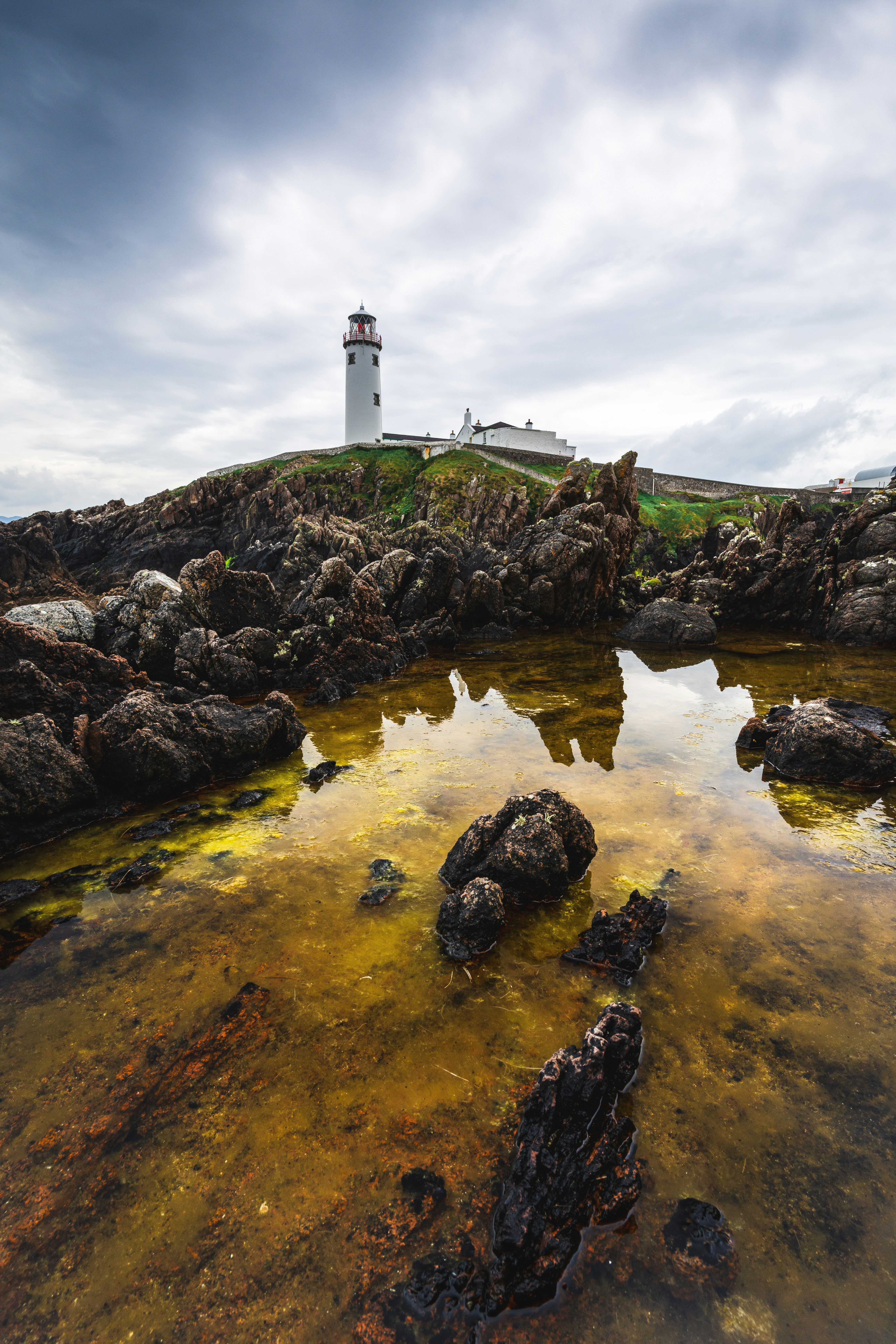 A light house sitting on top of a rocky shore