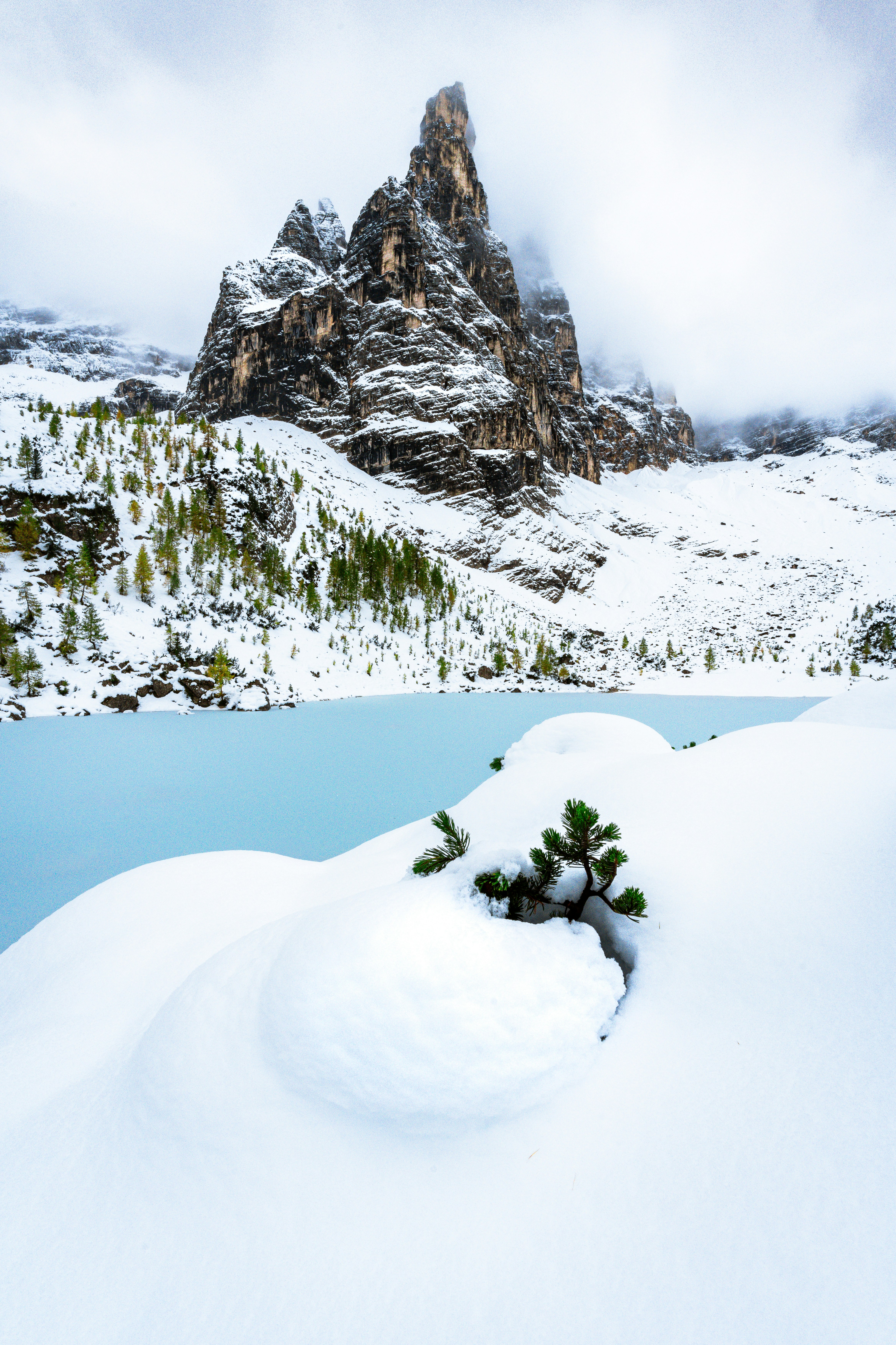A snowy landscape with a mountain in the background