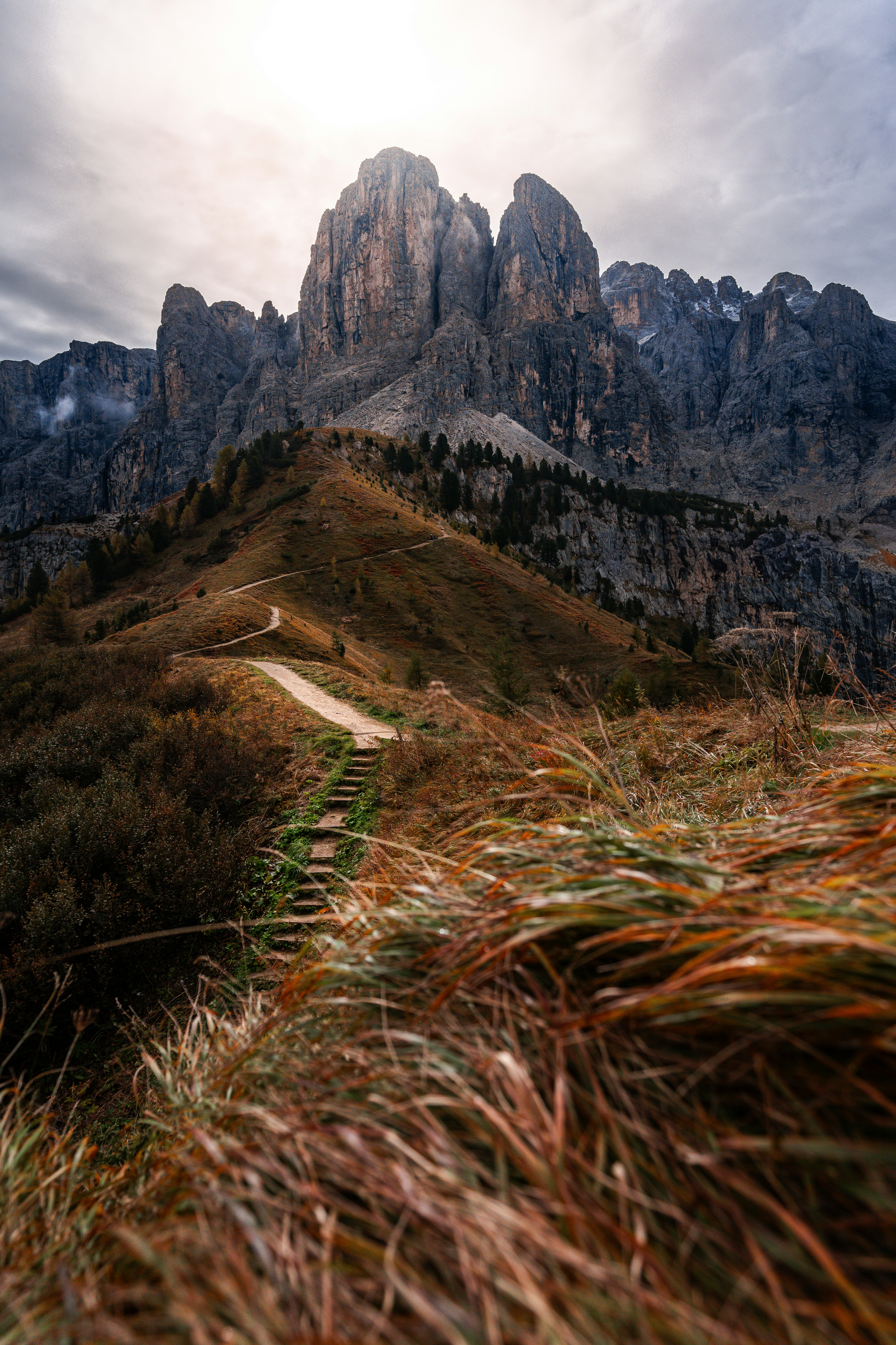 A grassy hill with a path going up it