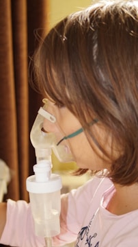 A young girl is using a machine to fill up a bottle