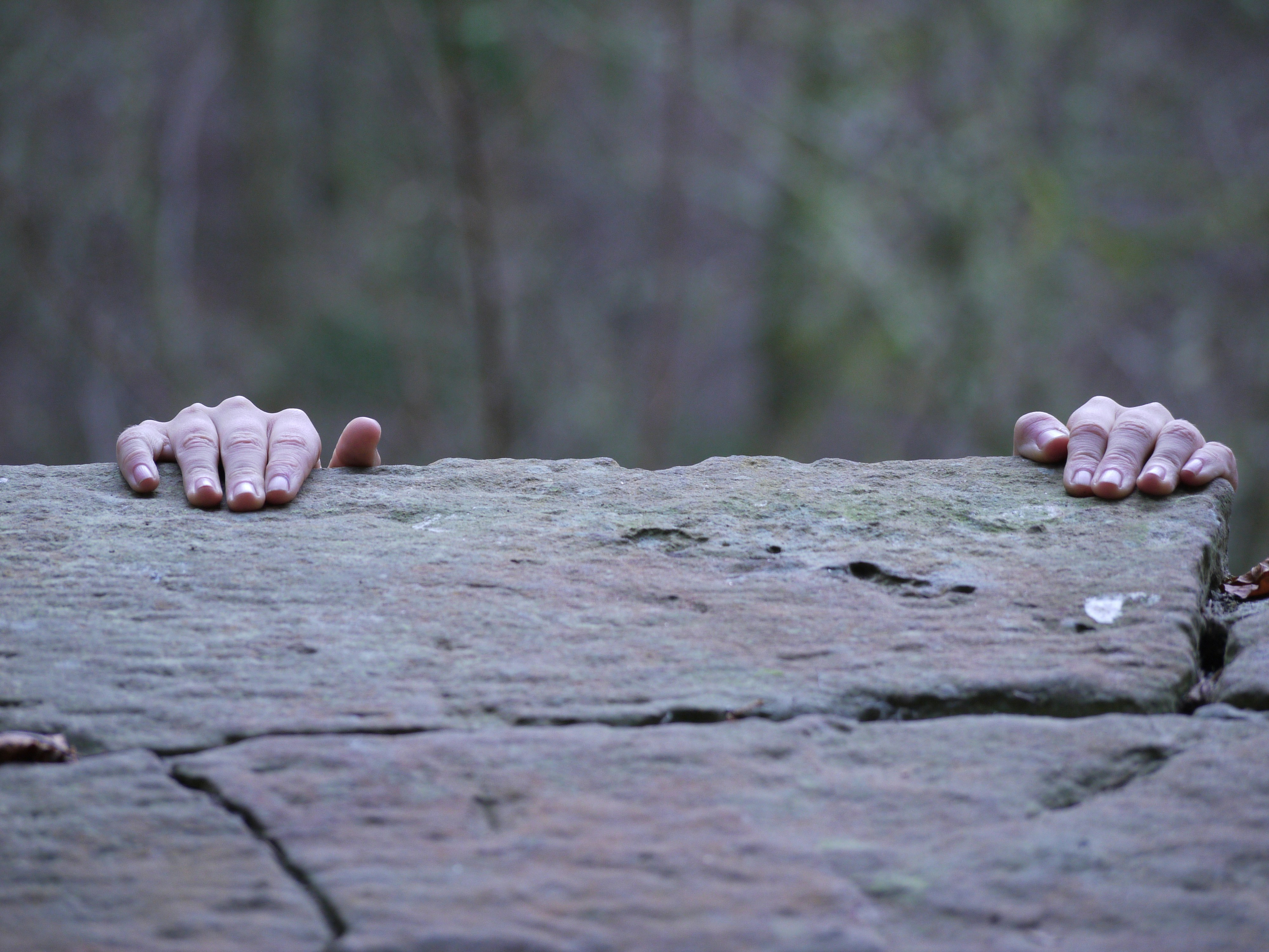 climber's hands gripping rock hold - climbing finger injury prevention