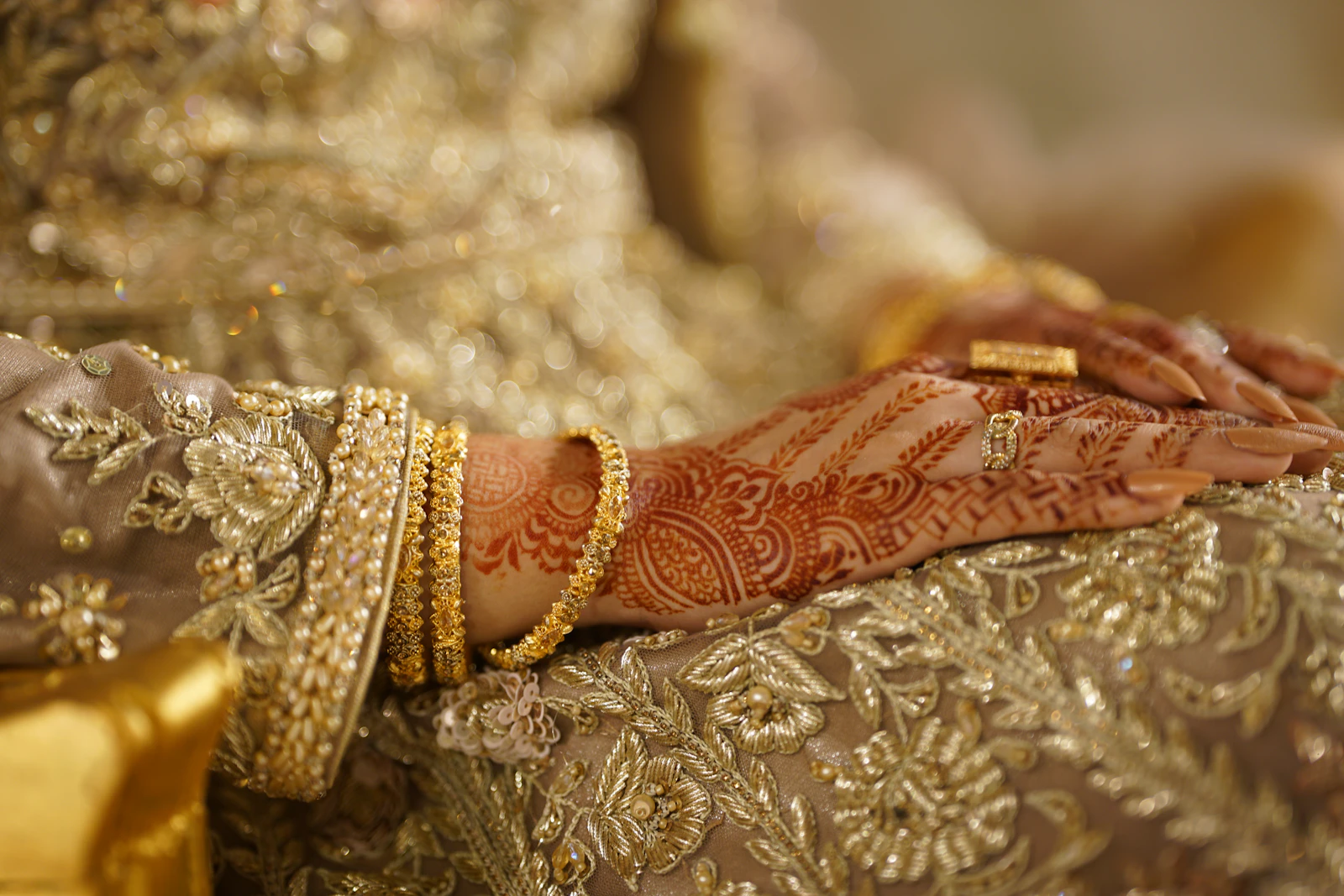 A close-up of a bride's hands wearing heirloom gold jewellery