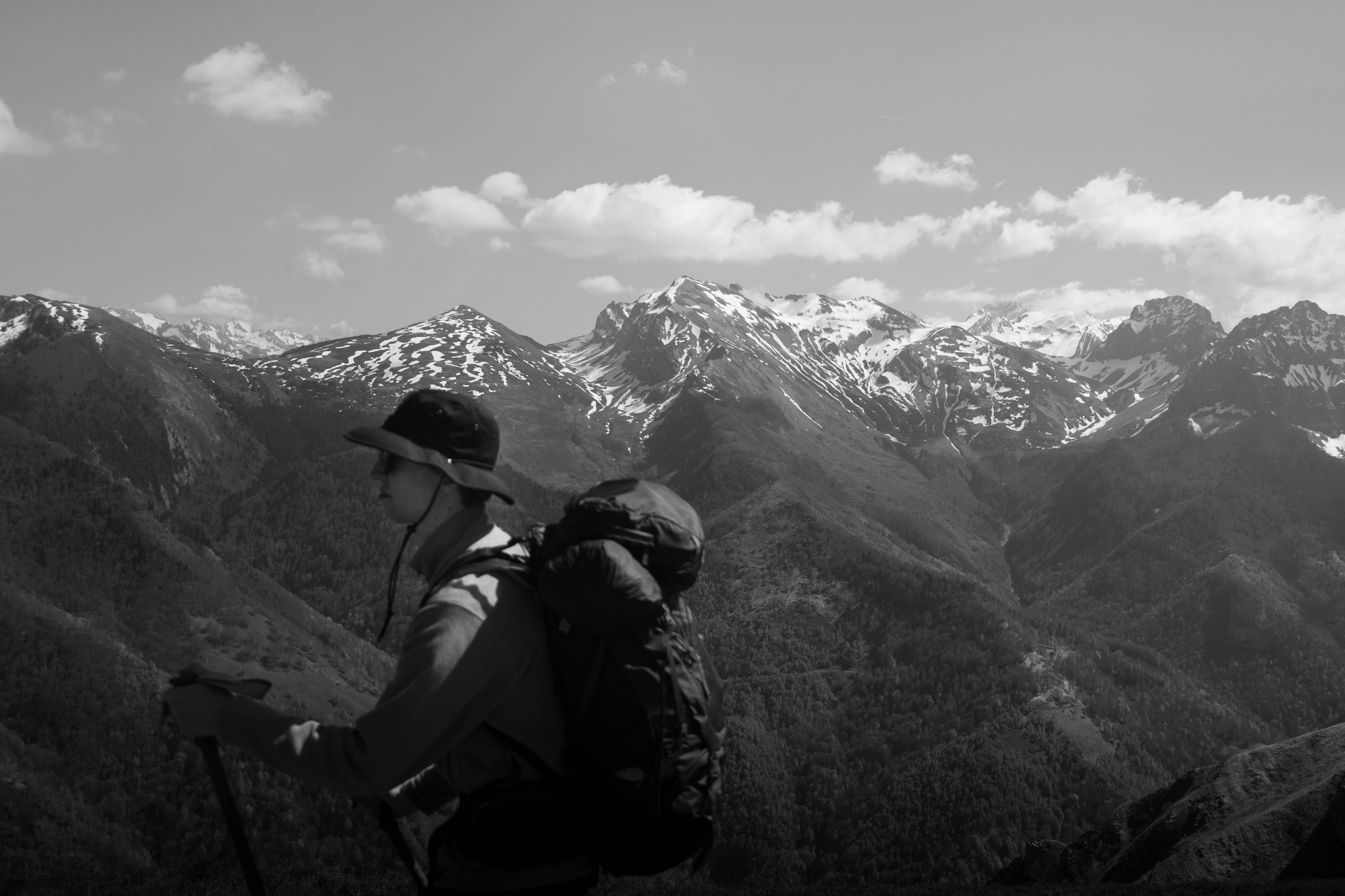 A black and white photo of a hiker on a mountain