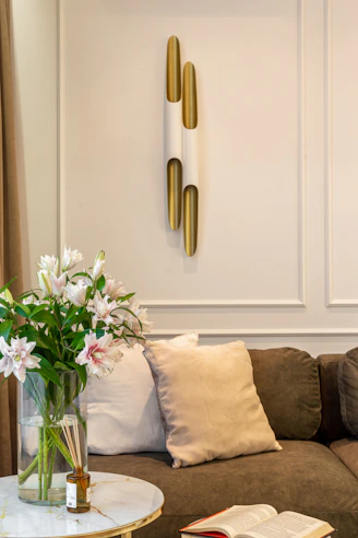 A living room filled with furniture and a vase of flowers