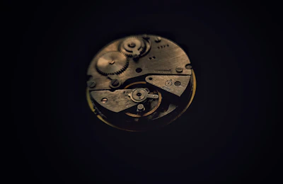 A close up of a clock face in the dark