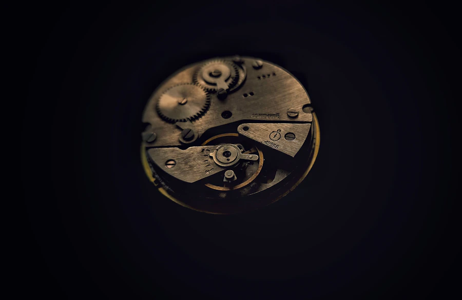 Macro view of an exposed mechanical watch movement with gears and jewels