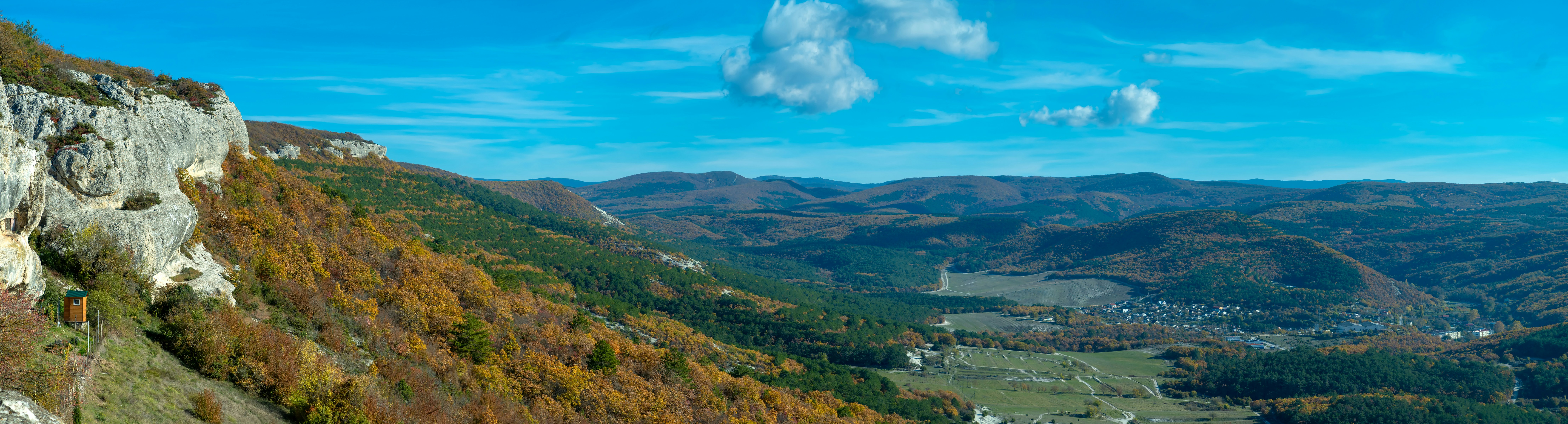 A blurry photo of a mountain with a river below