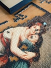 A picture of a woman holding a child on a puzzle