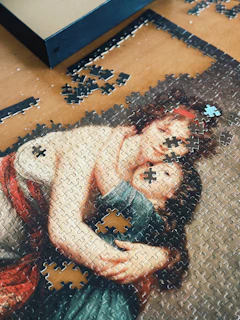 A picture of a woman holding a child on a puzzle