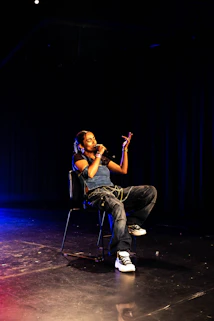 A man sitting in a chair on a stage