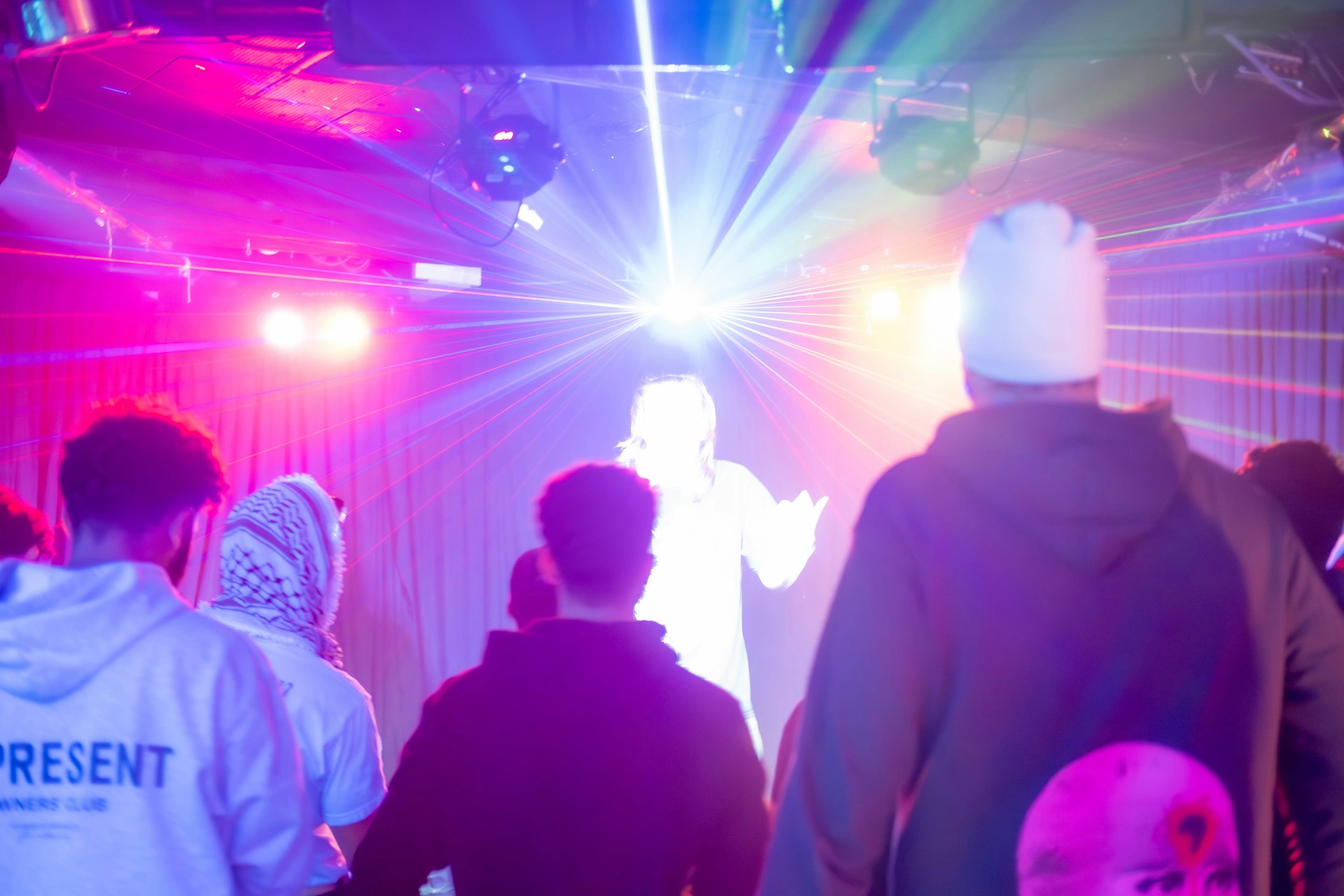 A group of people standing in front of a stage