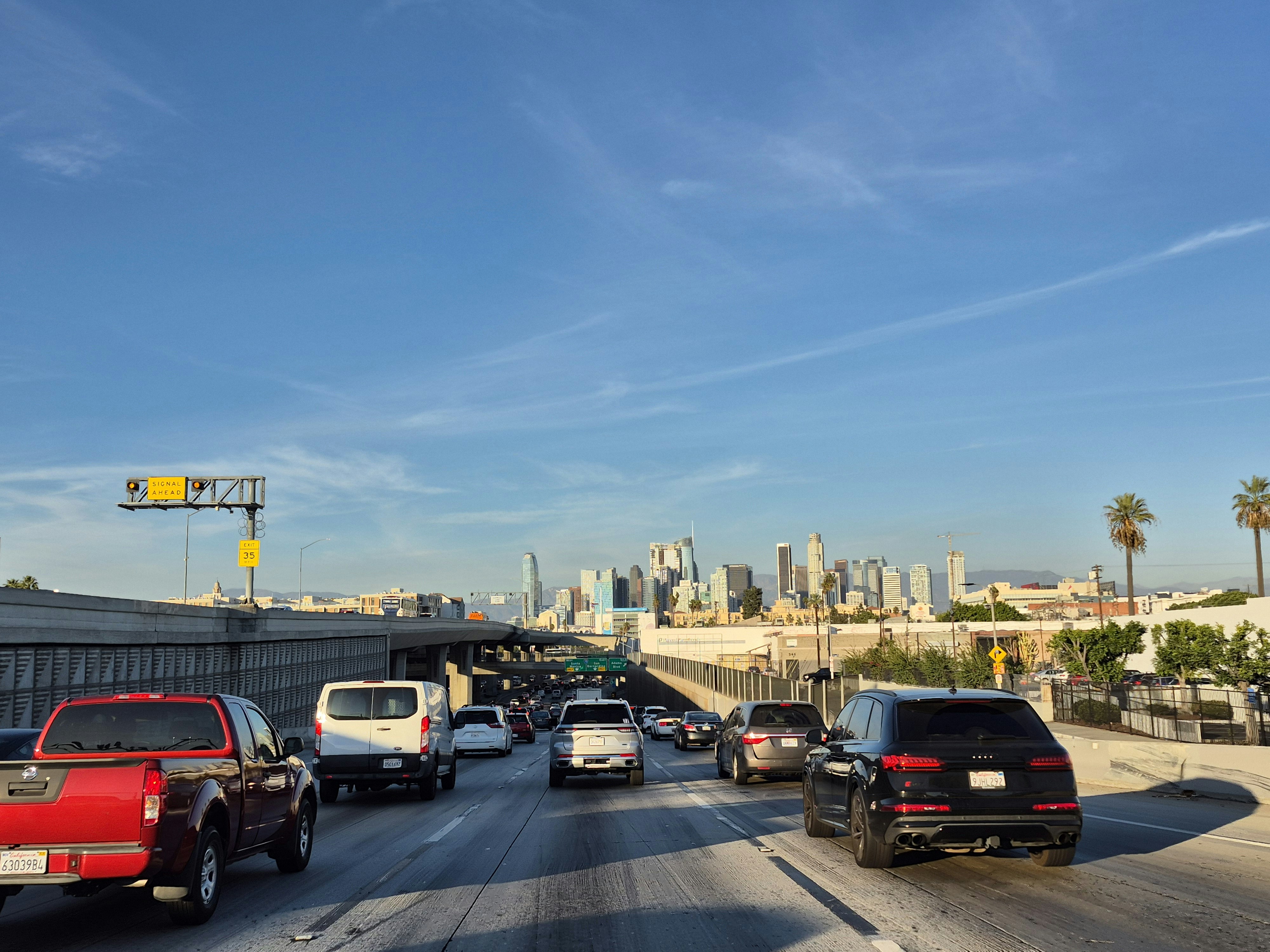 A bunch of cars that are driving down the street