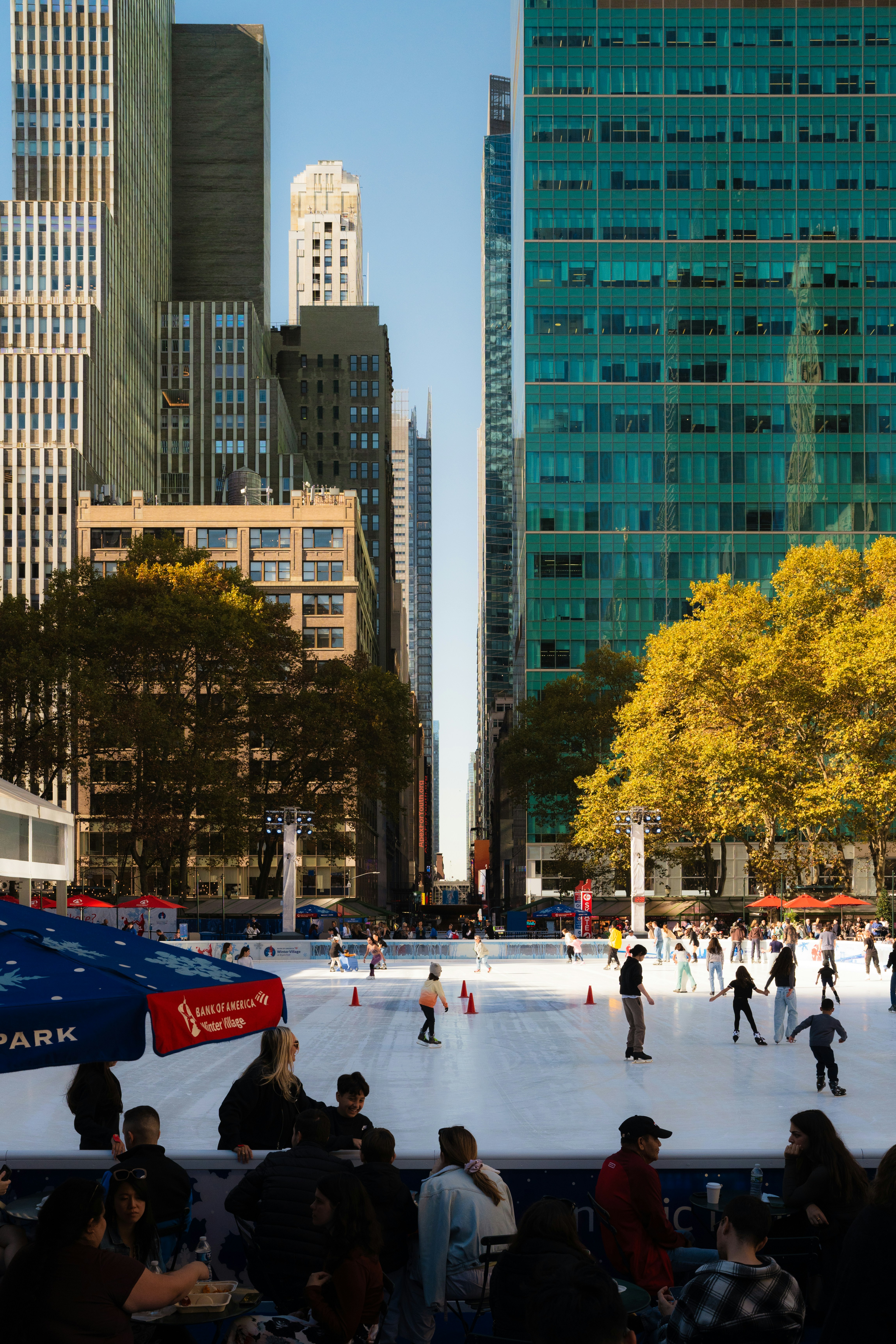 A group of people skating on an ice rink