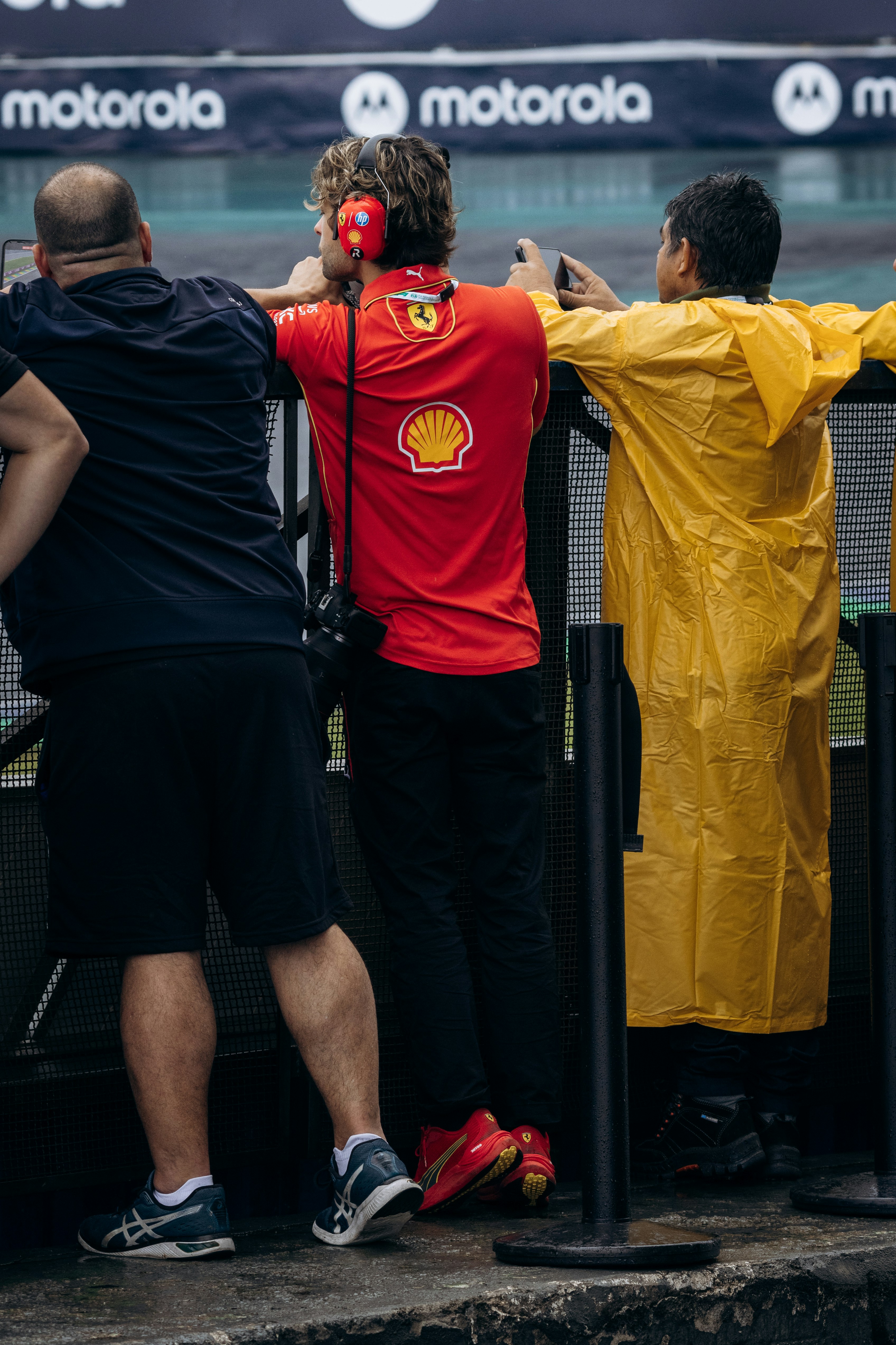 A group of people standing next to each other near a fence