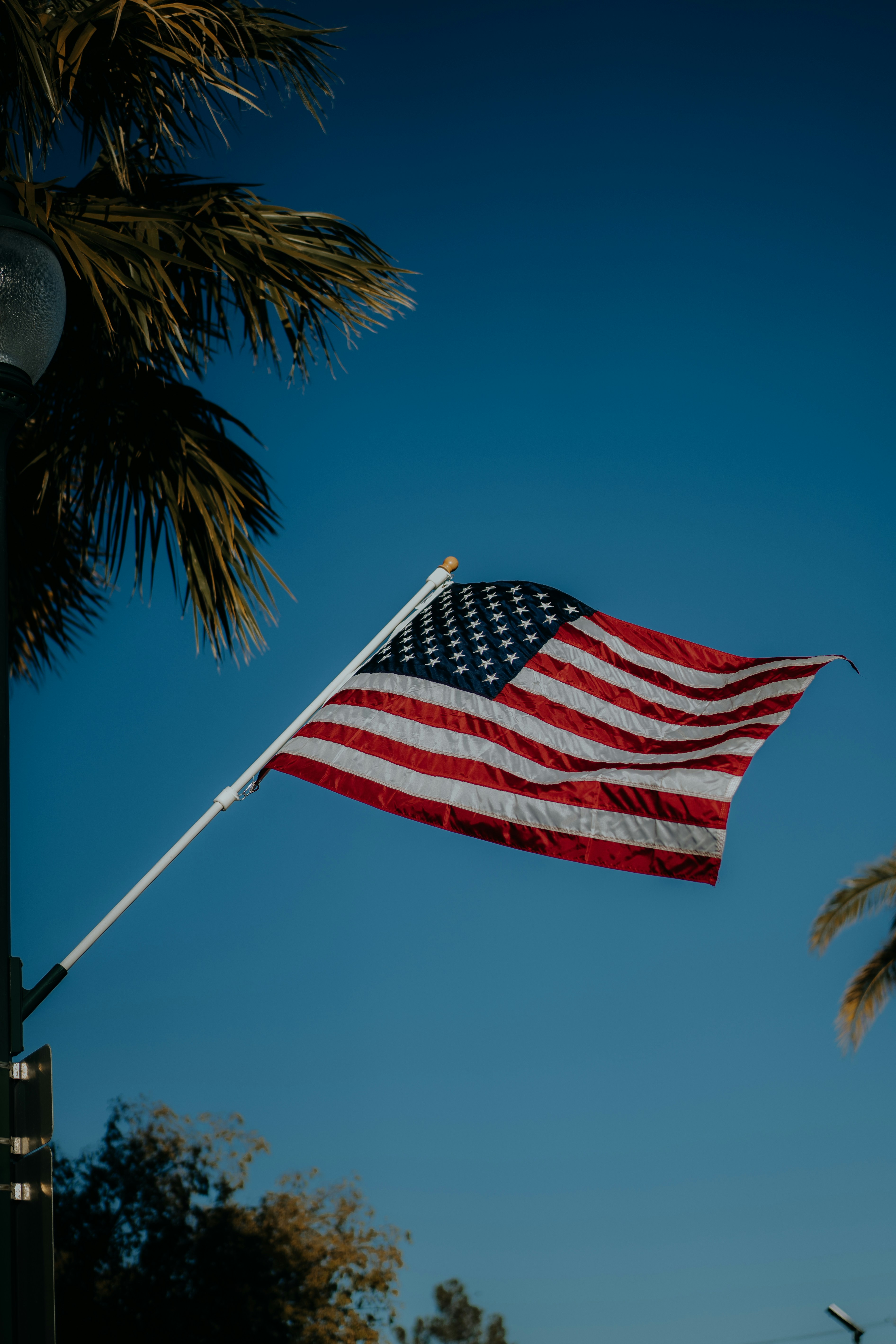A large american flag flying in the wind
