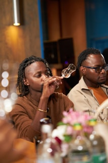 A group of people sitting at a table drinking wine