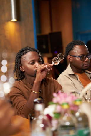 A group of people sitting at a table drinking wine