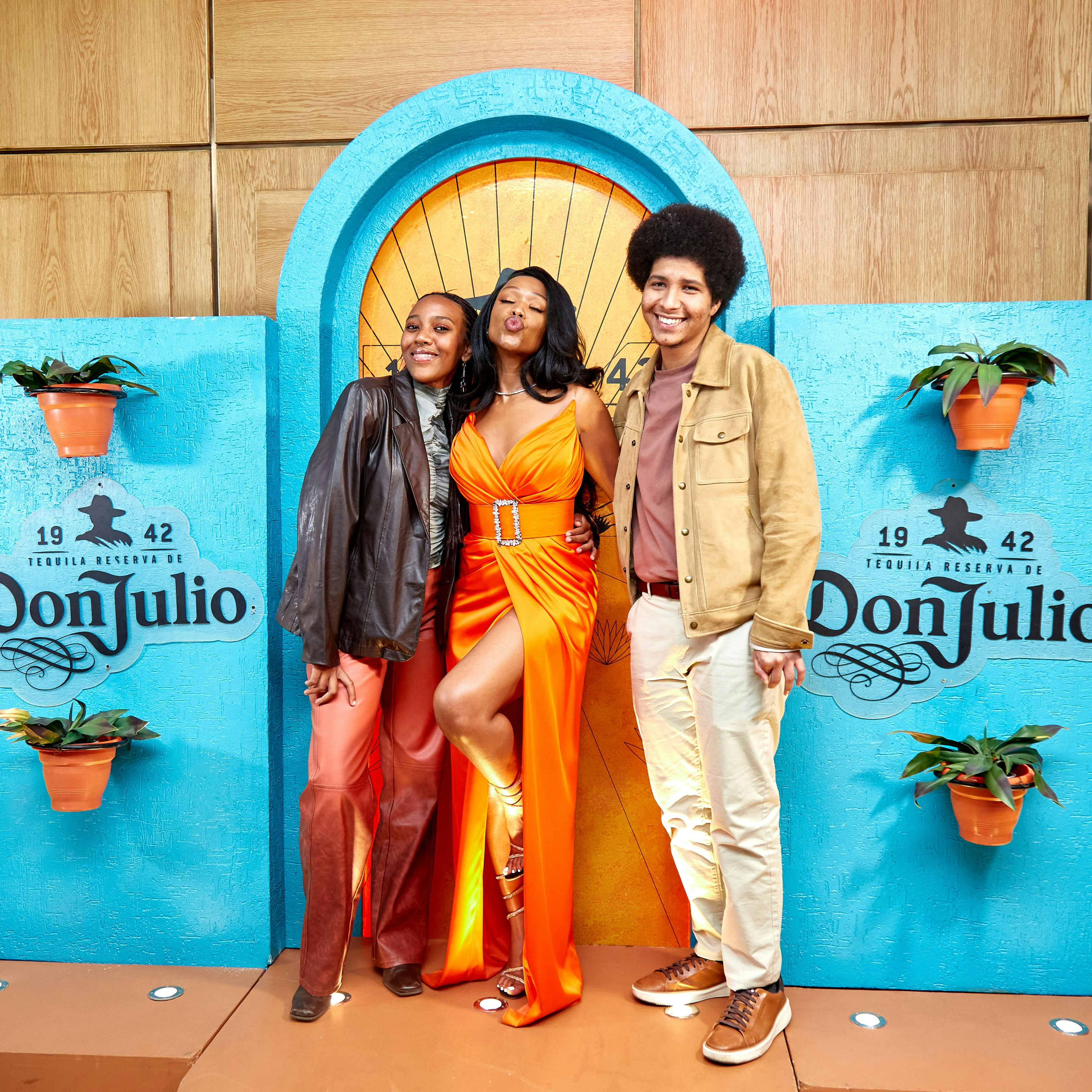 A man and two women standing in front of a door