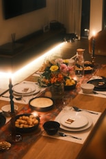 A long table with plates and candles on it