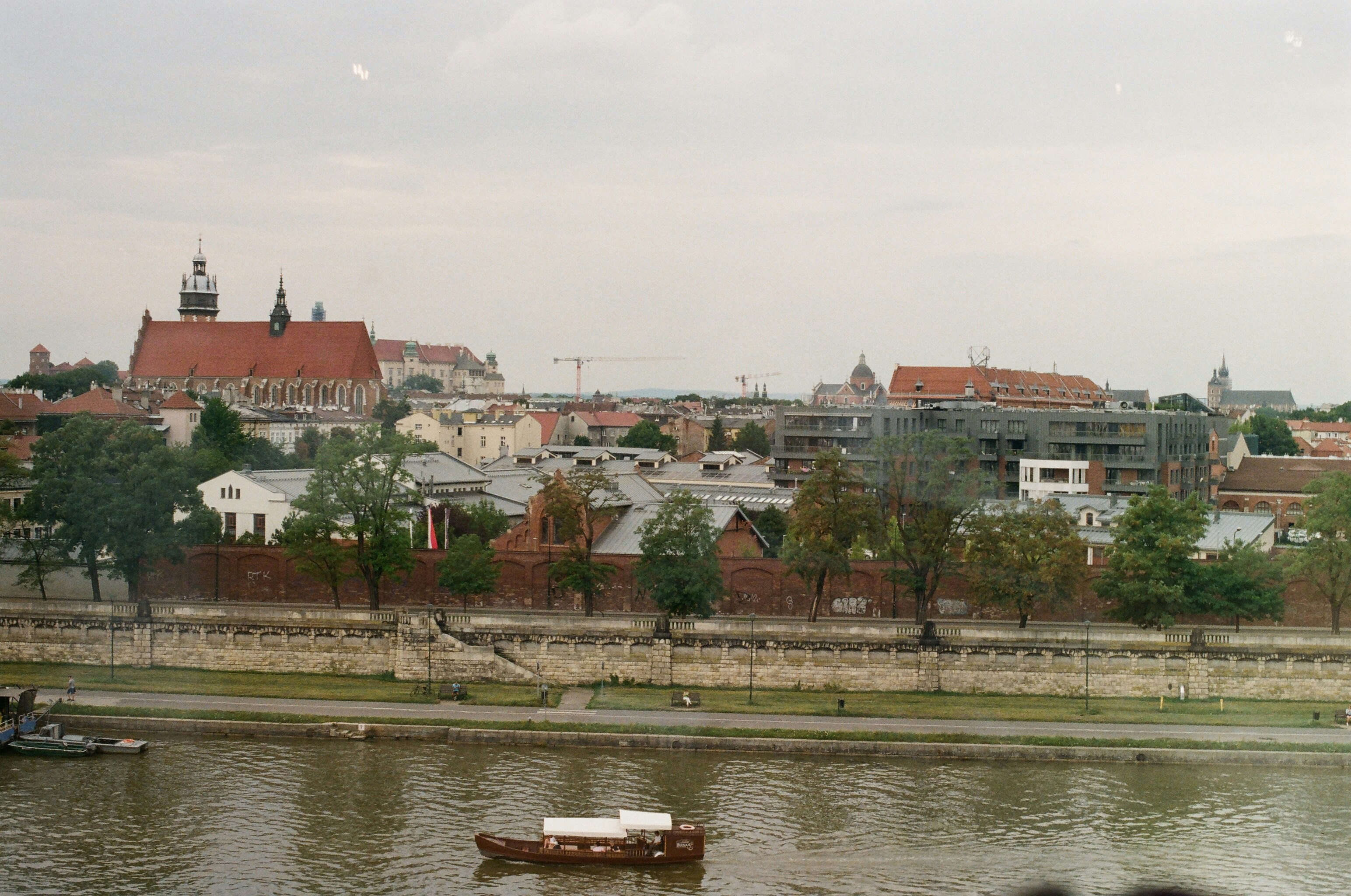 A river with a boat in it and a city in the background
