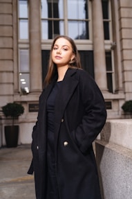A woman standing in front of a building