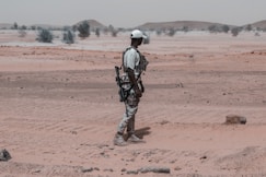 A man standing in the middle of a desert