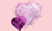 A heart shaped object with pink and white sprinkles