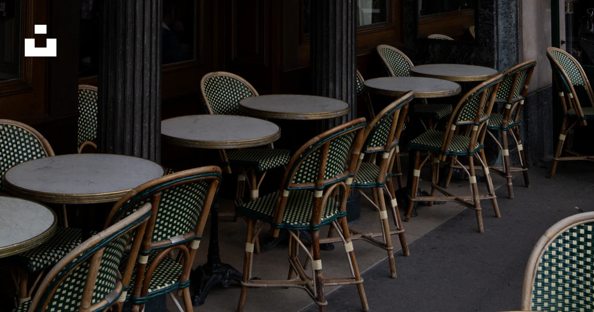 A row of tables and chairs outside of a restaurant photo – Free ...