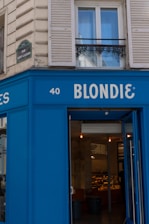 A blue building with a sign that says blondie