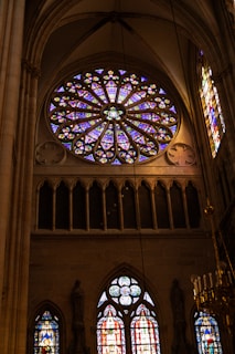 A large stained glass window inside of a cathedral