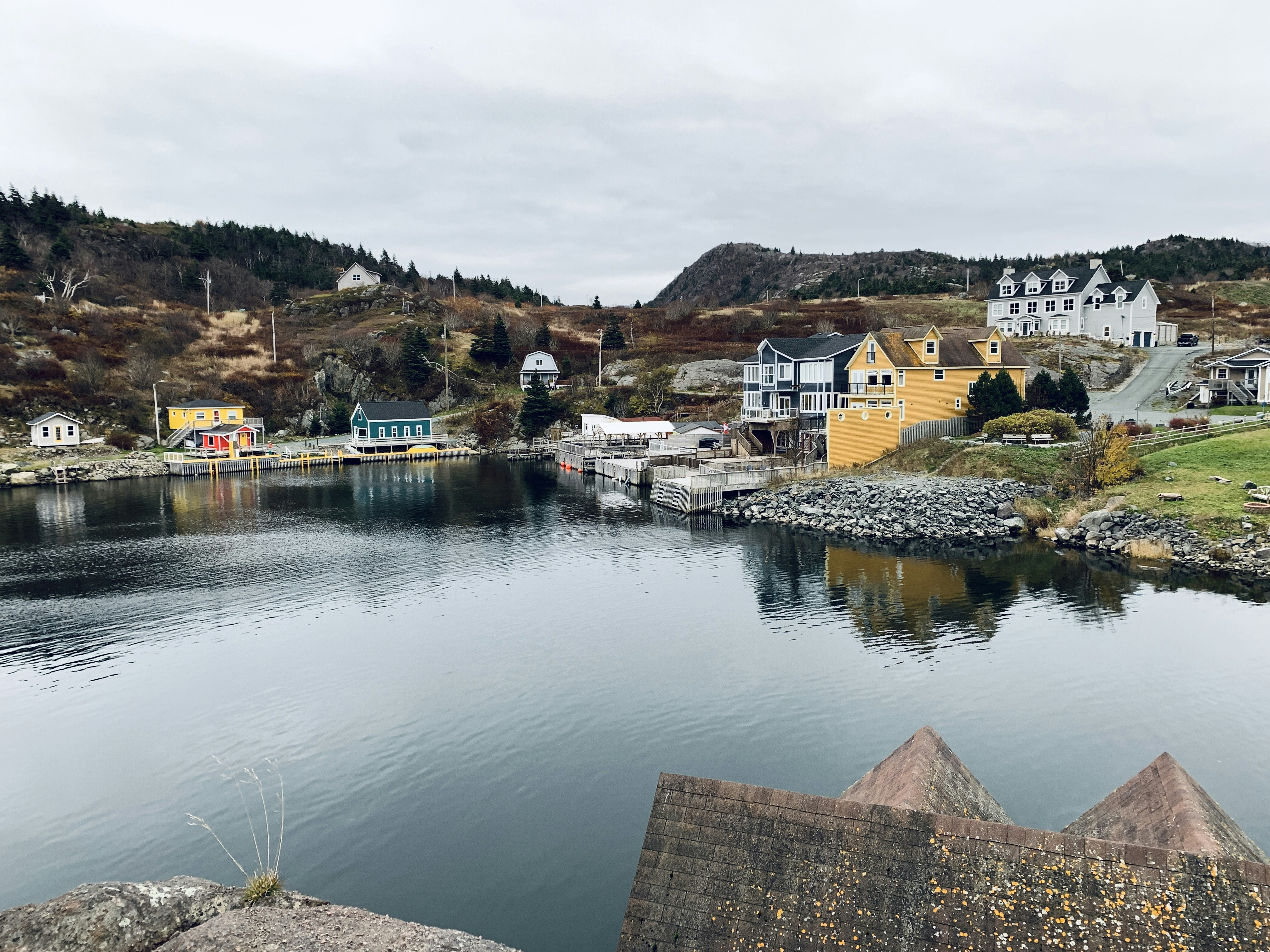 A body of water surrounded by mountains and houses