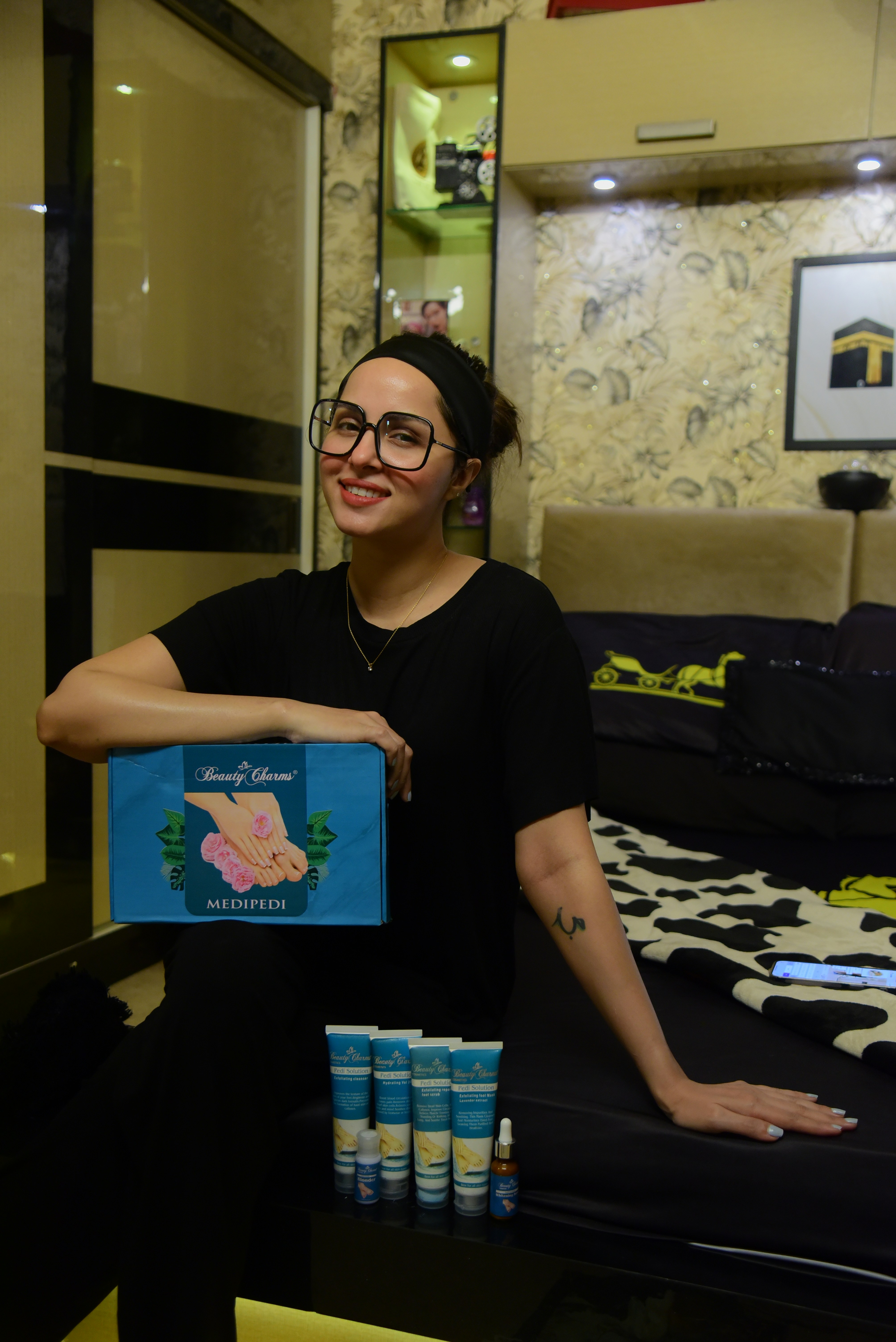 A woman standing in a room holding a box of toothpaste